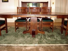 Side view with all four leaves installed and the extra two pairs of hinged legs extended to support the table at the ends.